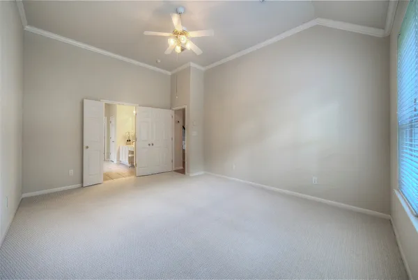 an empty room with a bathroom and a shower