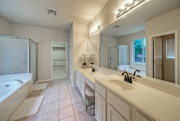 a bathroom with a sink a tub and a mirror