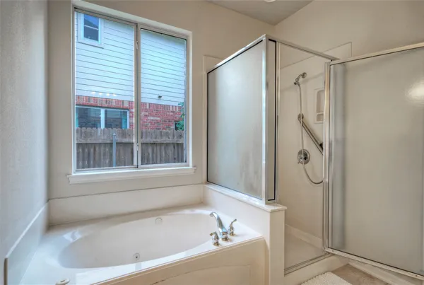 a bathroom with a bathtub and a shower