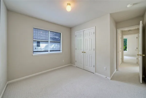 an empty room with windows and closet