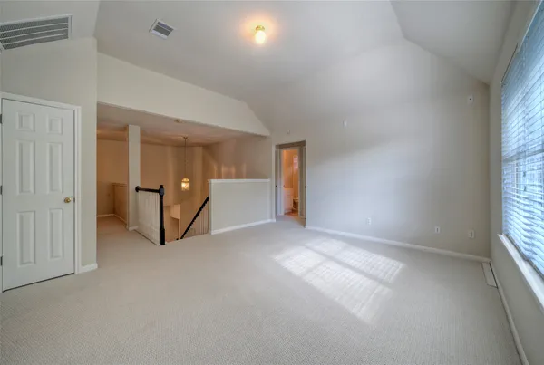 an empty room with windows and entrance