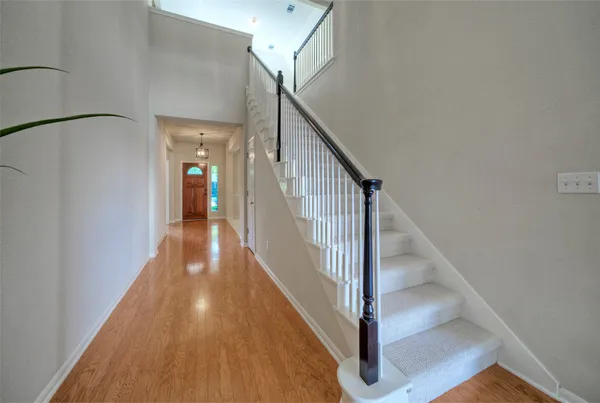 a view of a hallway with wooden floor