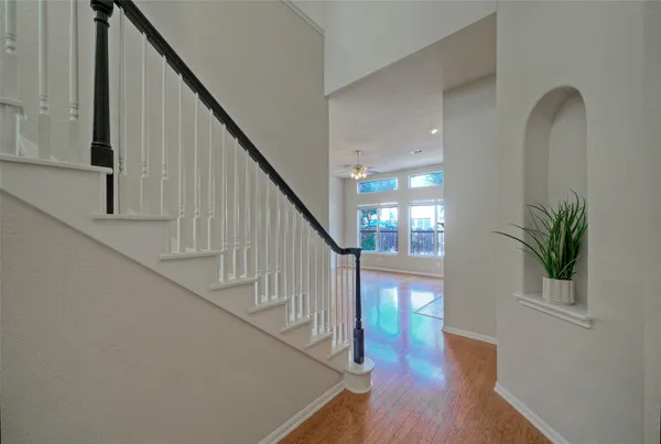a view of entryway and hall with wooden floor