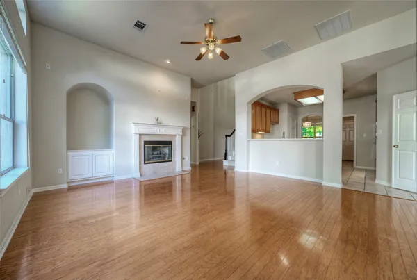 wooden floor in an empty room with a window