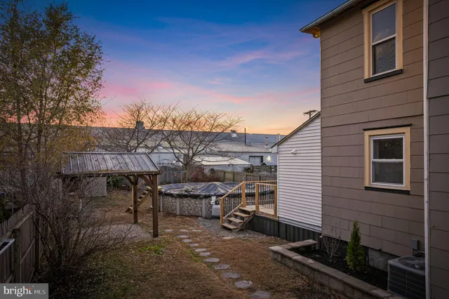 a view of a house with a yard and sitting area