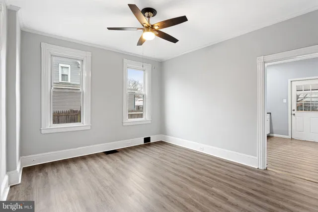 wooden floor in an empty room with a window