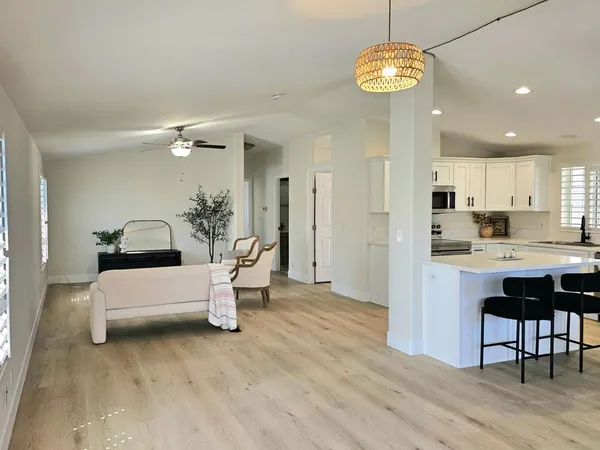 a view of kitchen with dining table and wooden floor