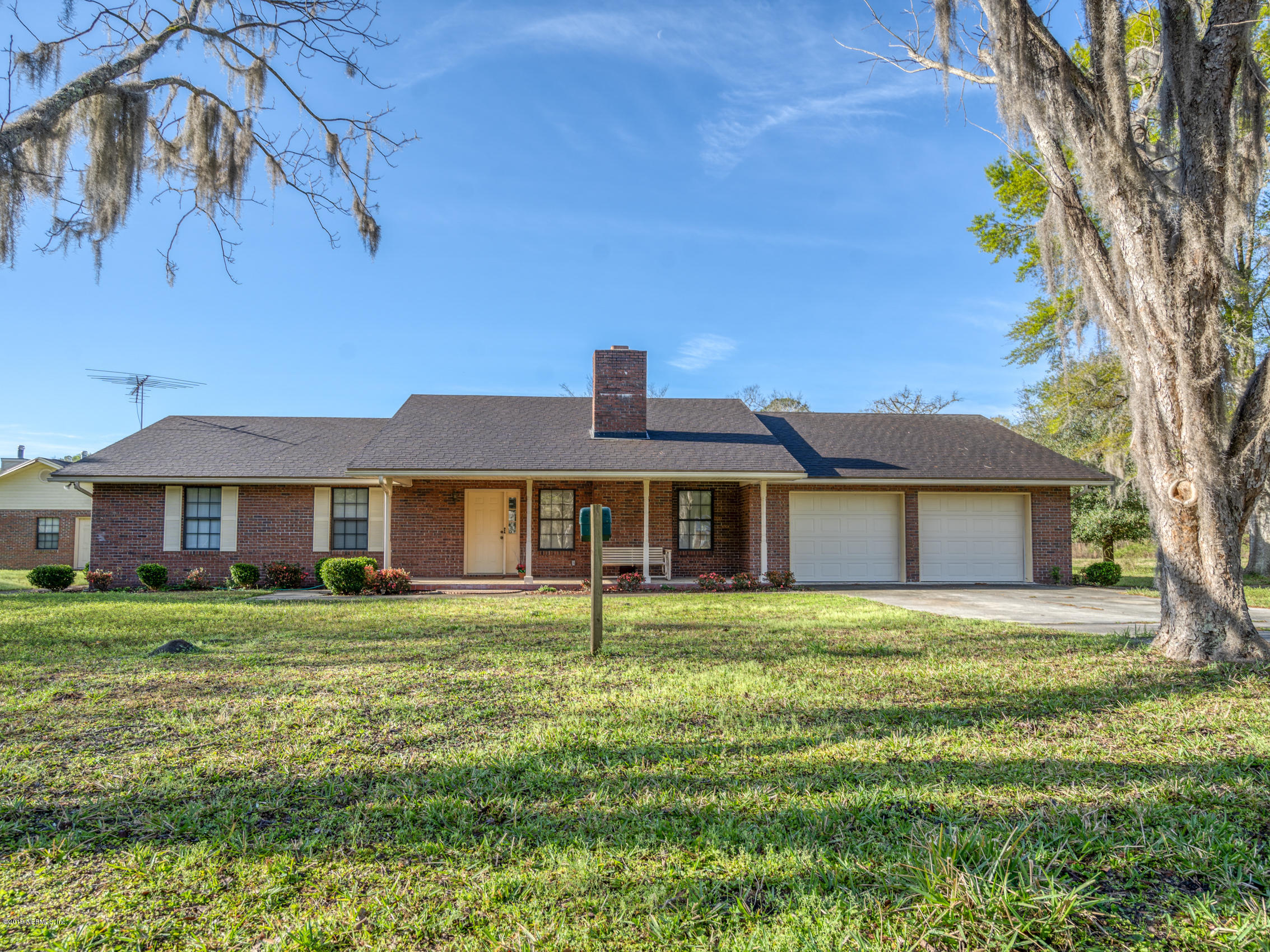 54814 Ogilvie Road Callahan, FL 32011 - Photo 1 of 30 a front view of a house with a garden
