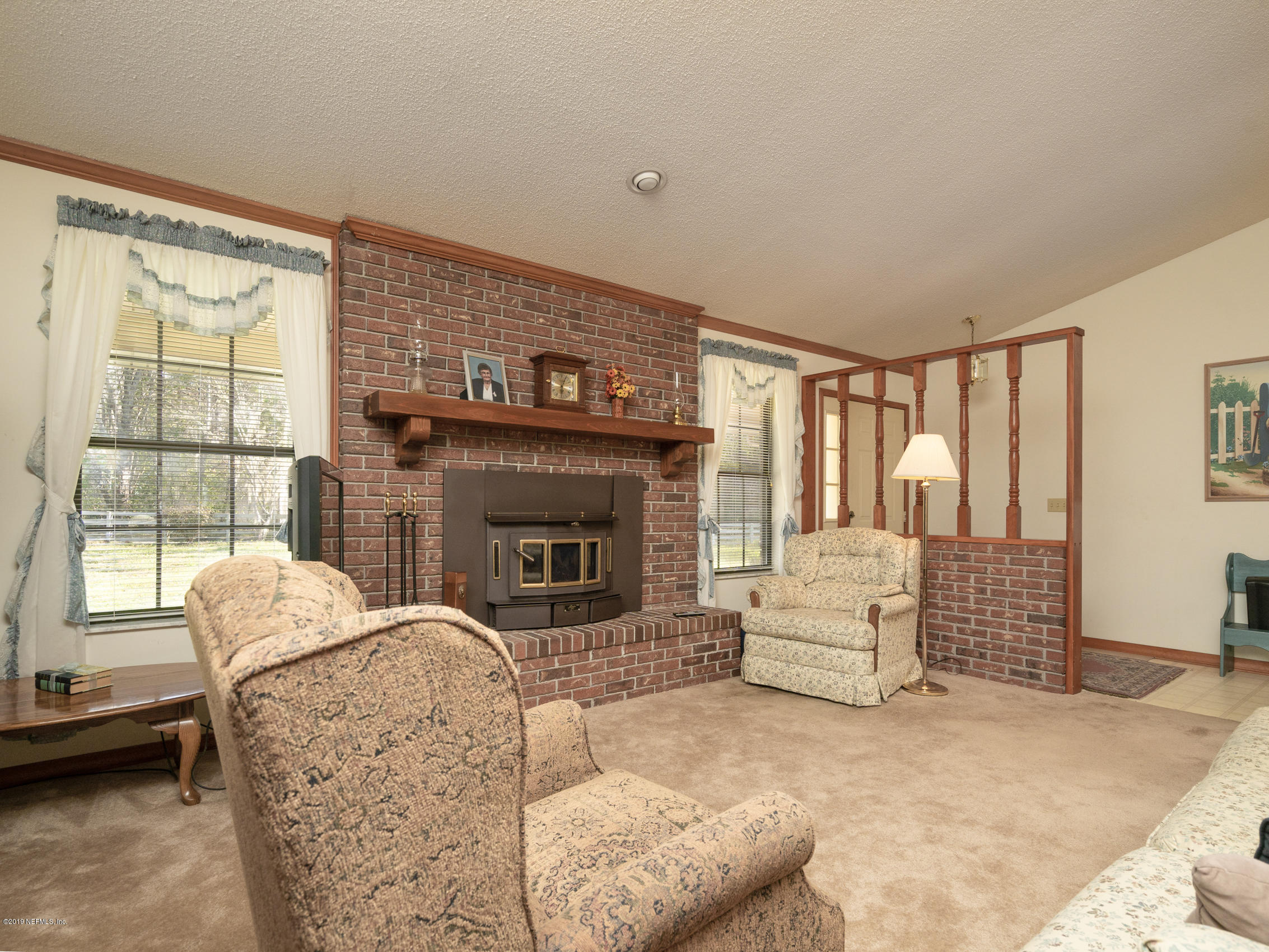 54814 Ogilvie Road Callahan, FL 32011 - Photo 5 of 30 a living room with furniture and a fireplace