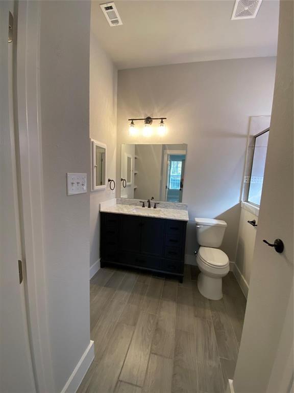 411 Cleveland Road Granbury, TX 76049 - Photo 11 of 21 a bathroom with a sink a toilet and a mirror