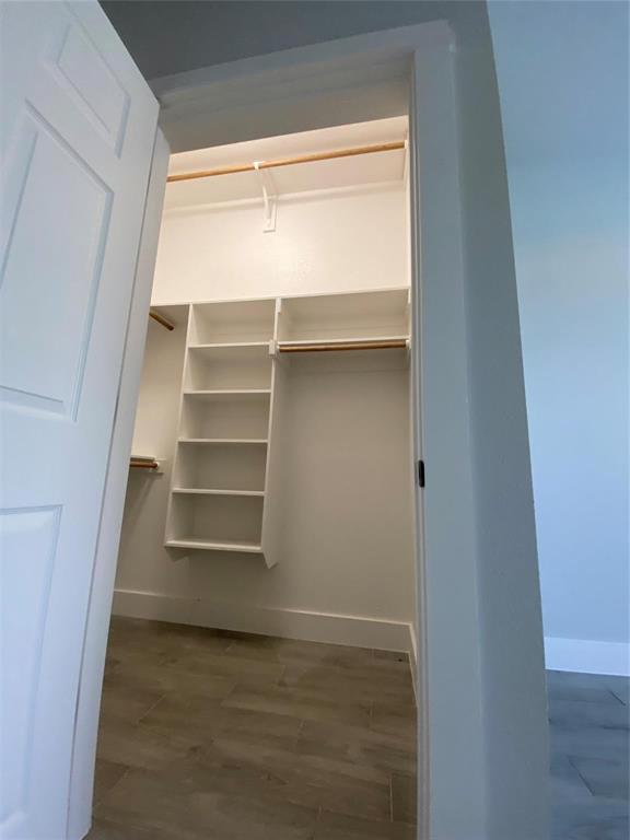 411 Cleveland Road Granbury, TX 76049 - Photo 13 of 21 a view of walk in closet with empty racks