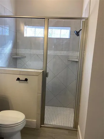 a bathroom with a glass shower door