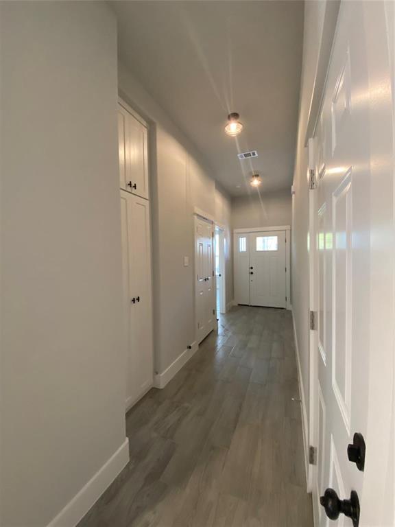 411 Cleveland Road Granbury, TX 76049 - Photo 19 of 21 a view of a hallway with wooden floor