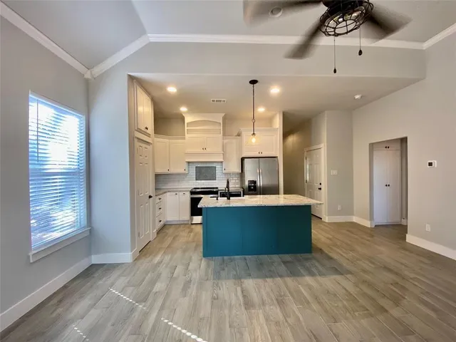 a view of kitchen and kitchen with wooden floor