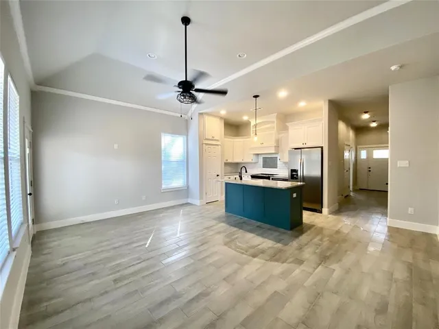 a large kitchen with a refrigerator and a sink