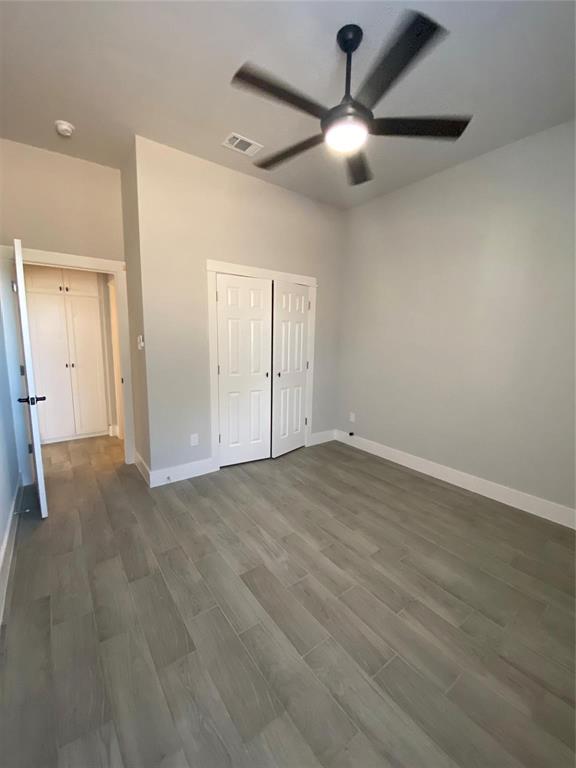 411 Cleveland Road Granbury, TX 76049 - Photo 9 of 21 an empty room with wooden floor fan and windows