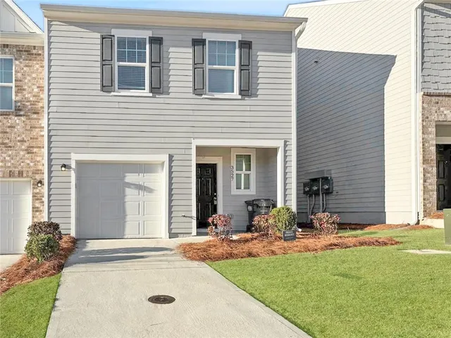a view of a house with yard tub and chairs
