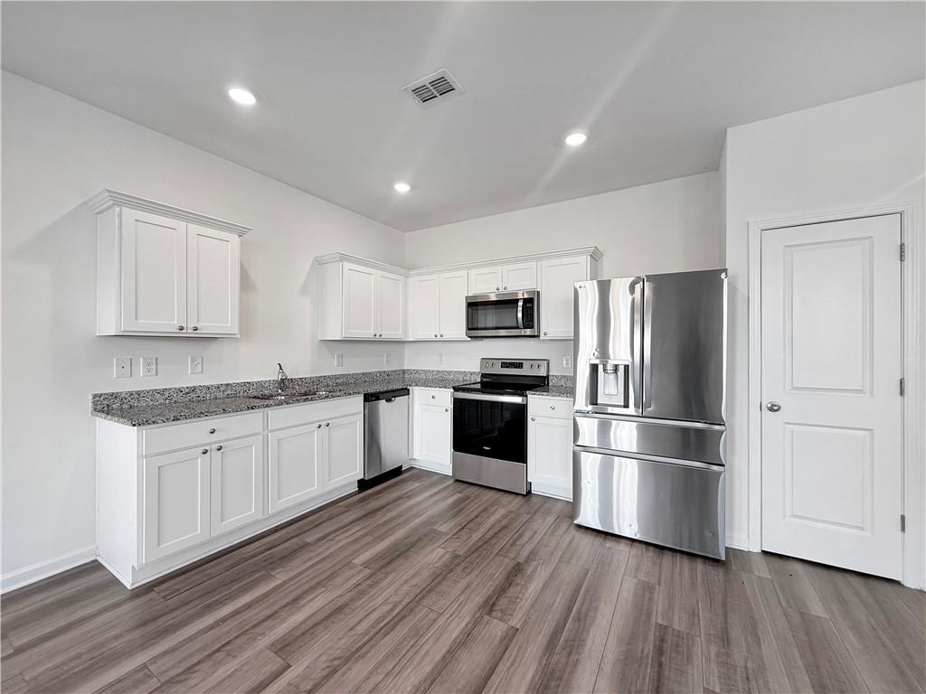 3527 Condor Court Atlanta, GA 30331 - Photo 5 of 21 a kitchen with granite countertop a refrigerator oven a sink dishwasher and a stove with wooden floor