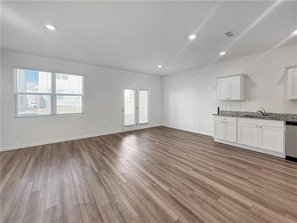 3527 Condor Court Atlanta, GA 30331 - Photo 7 of 21 an empty room with wooden floor and windows