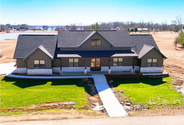 a view of a house with pool and chairs