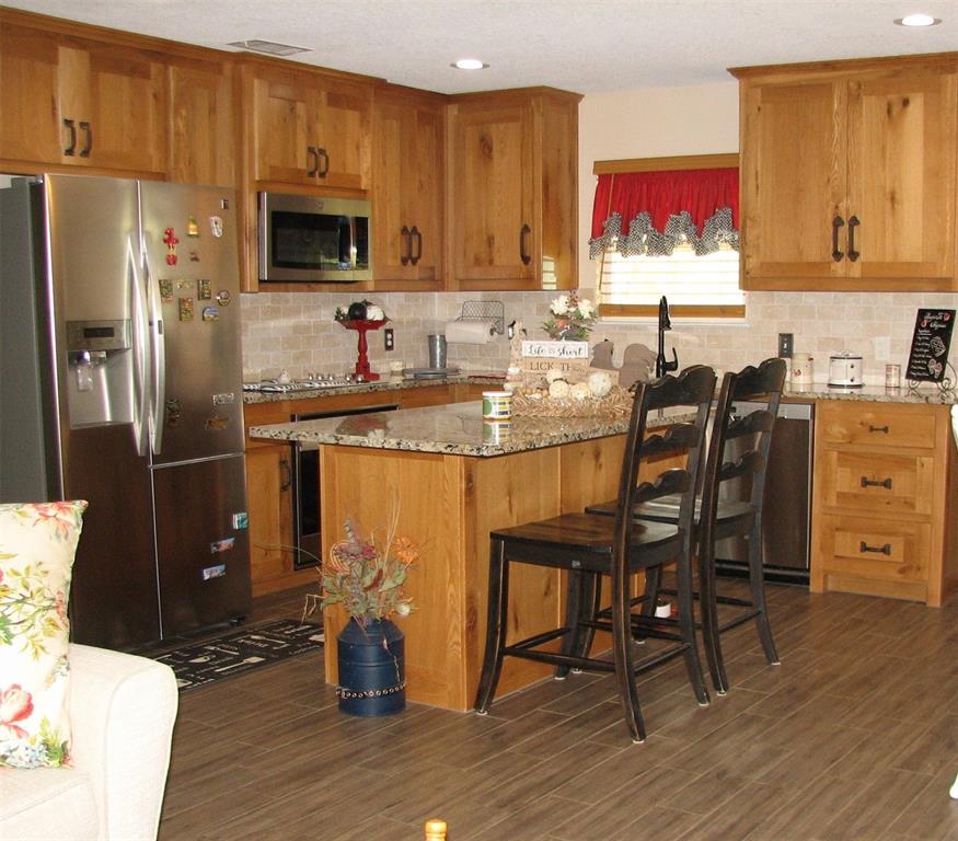 511 Erwin Road Poolville, TX 76487 - Photo 12 of 40 Open concept allows for eat in kitchen at the island
