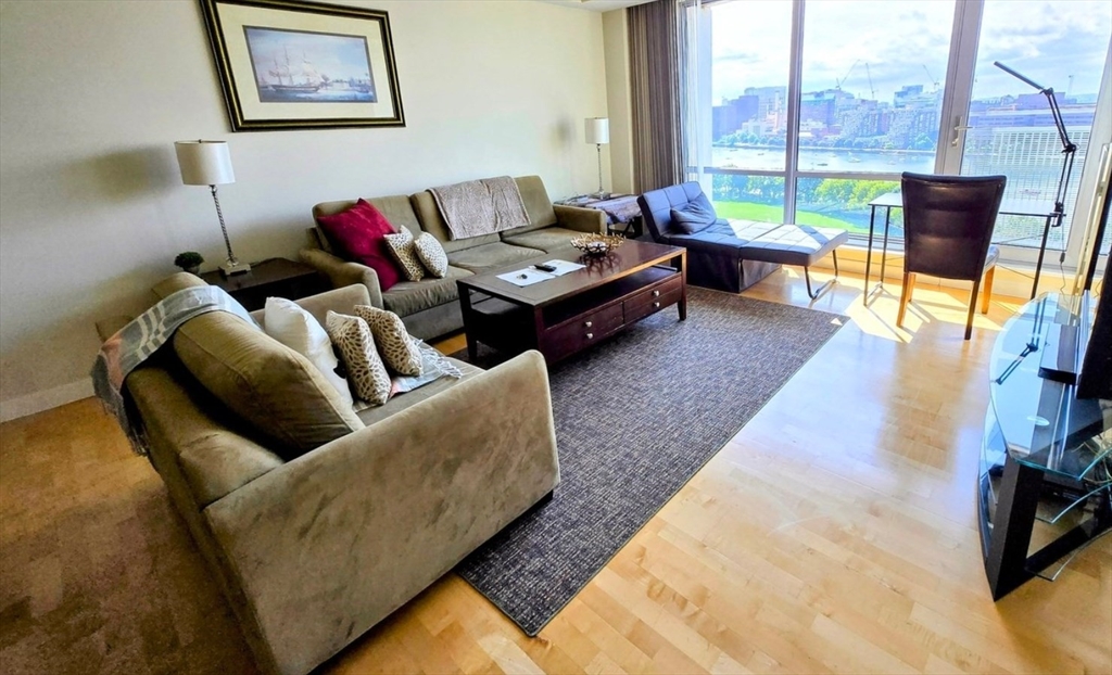 a living room with furniture and a floor to ceiling window