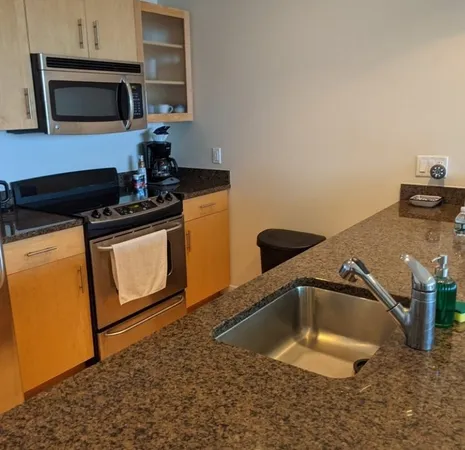 a kitchen with a sink and a stove top oven