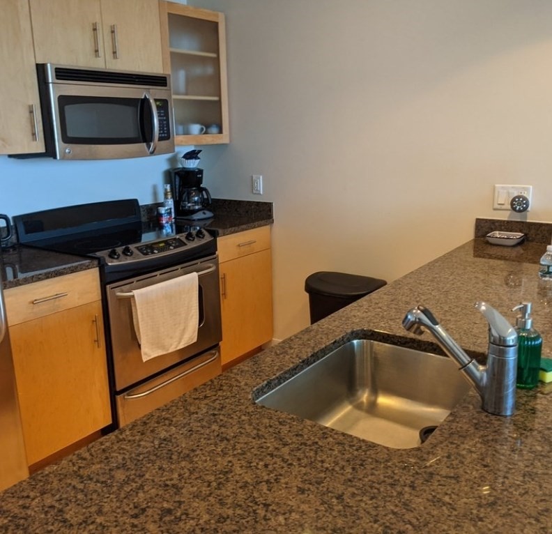 175 Blossom Street, Unit 4 Boston, MA 02114 - Photo 2 of 5 a kitchen with a sink and a stove top oven