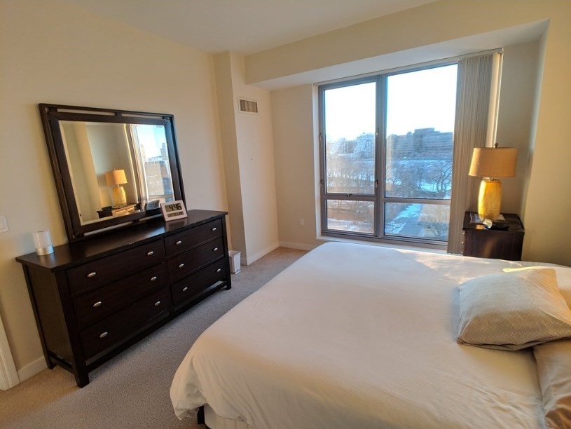 175 Blossom Street, Unit 4 Boston, MA 02114 - Photo 3 of 5 a bedroom with a bed and a mirror on dresser