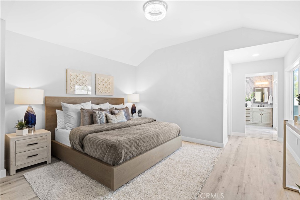 39 Cape Cod Irvine, CA 92620 - Photo 32 of 56 a spacious bedroom with a bed and a lamp