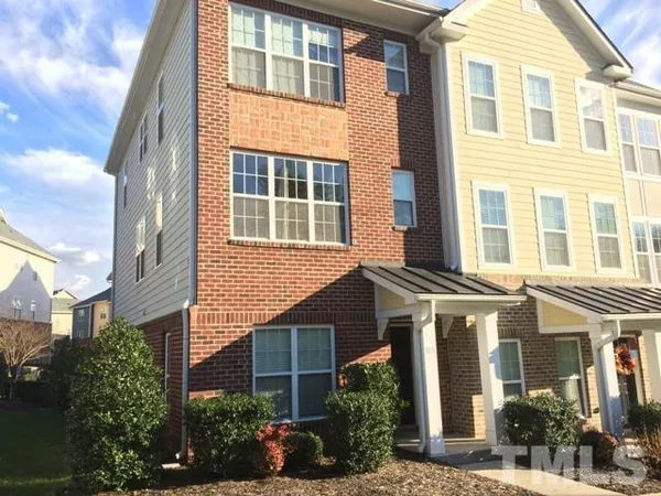 a view of a brick building next to a yard