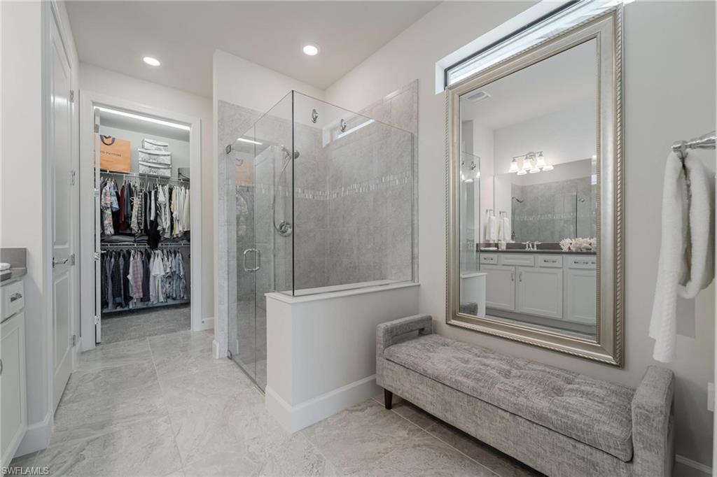 19855 Beverly Park Road Estero, FL 33928 - Photo 11 of 42 a bathroom with a tub shower sink and mirror