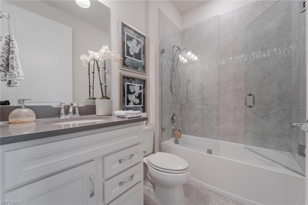 19855 Beverly Park Road Estero, FL 33928 - Photo 15 of 42 a bathroom with a double vanity sink a toilet and a bathtub