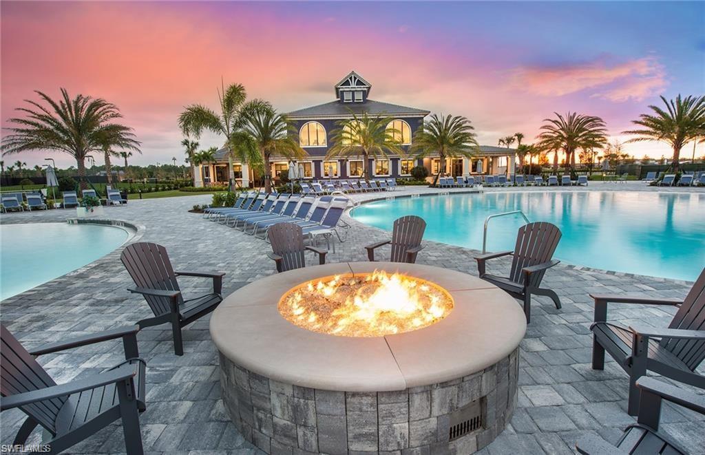 19855 Beverly Park Road Estero, FL 33928 - Photo 19 of 42 a view of a swimming pool with outdoor seating and plants