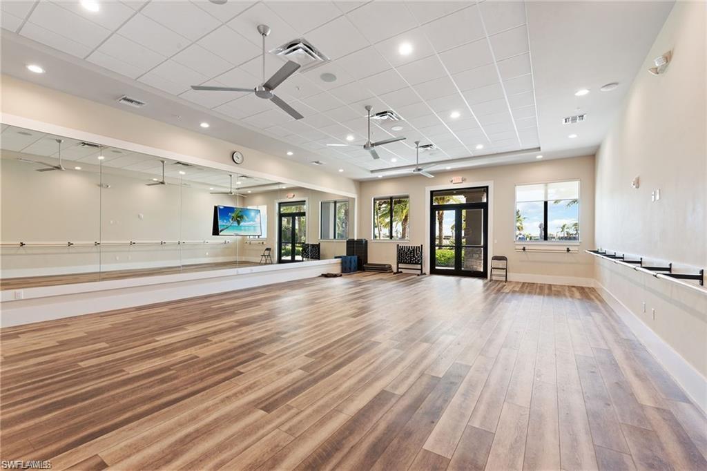19855 Beverly Park Road Estero, FL 33928 - Photo 35 of 42 an empty room with wooden floor and windows