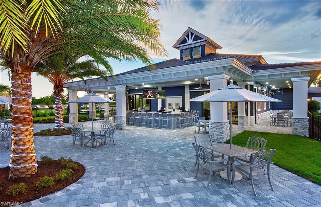 19855 Beverly Park Road Estero, FL 33928 - Photo 40 of 42 a view of a patio with table and chairs under an umbrella