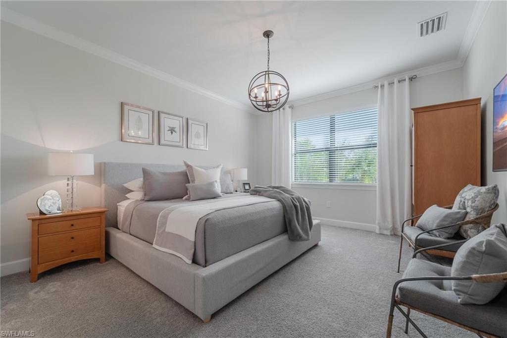 19855 Beverly Park Road Estero, FL 33928 - Photo 9 of 42 a spacious bedroom with a bed and a large window