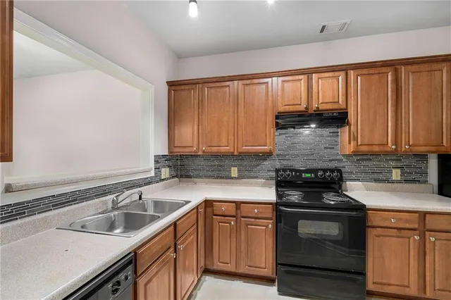 a kitchen with a stove a sink and a microwave