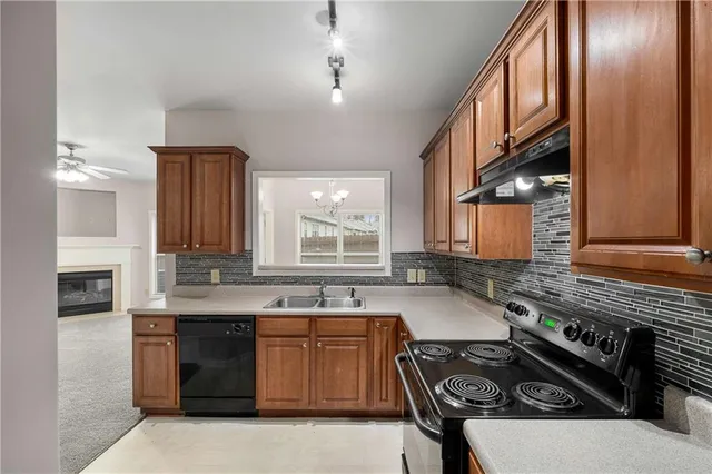 a kitchen that has a sink and a stove