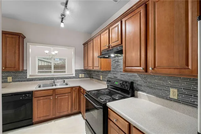 a kitchen with stainless steel appliances granite countertop a refrigerator sink and cabinets