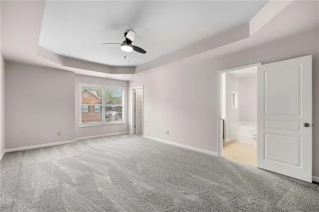 an empty room with windows and cabinet