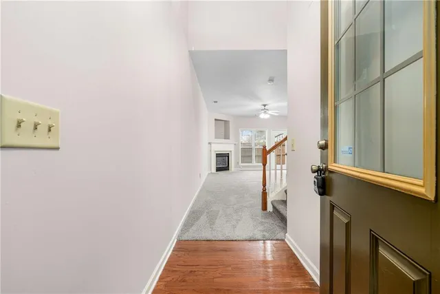 a view of entryway and hall with wooden floor