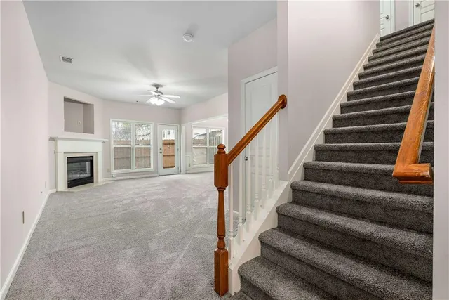 a view of an empty room with a fireplace and a window