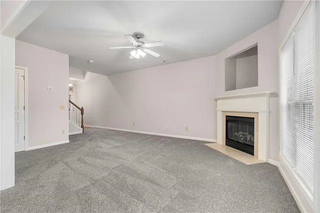 a view of an empty room with a fireplace