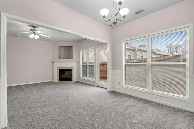 a view of a livingroom with a ceiling fan window and a fireplace