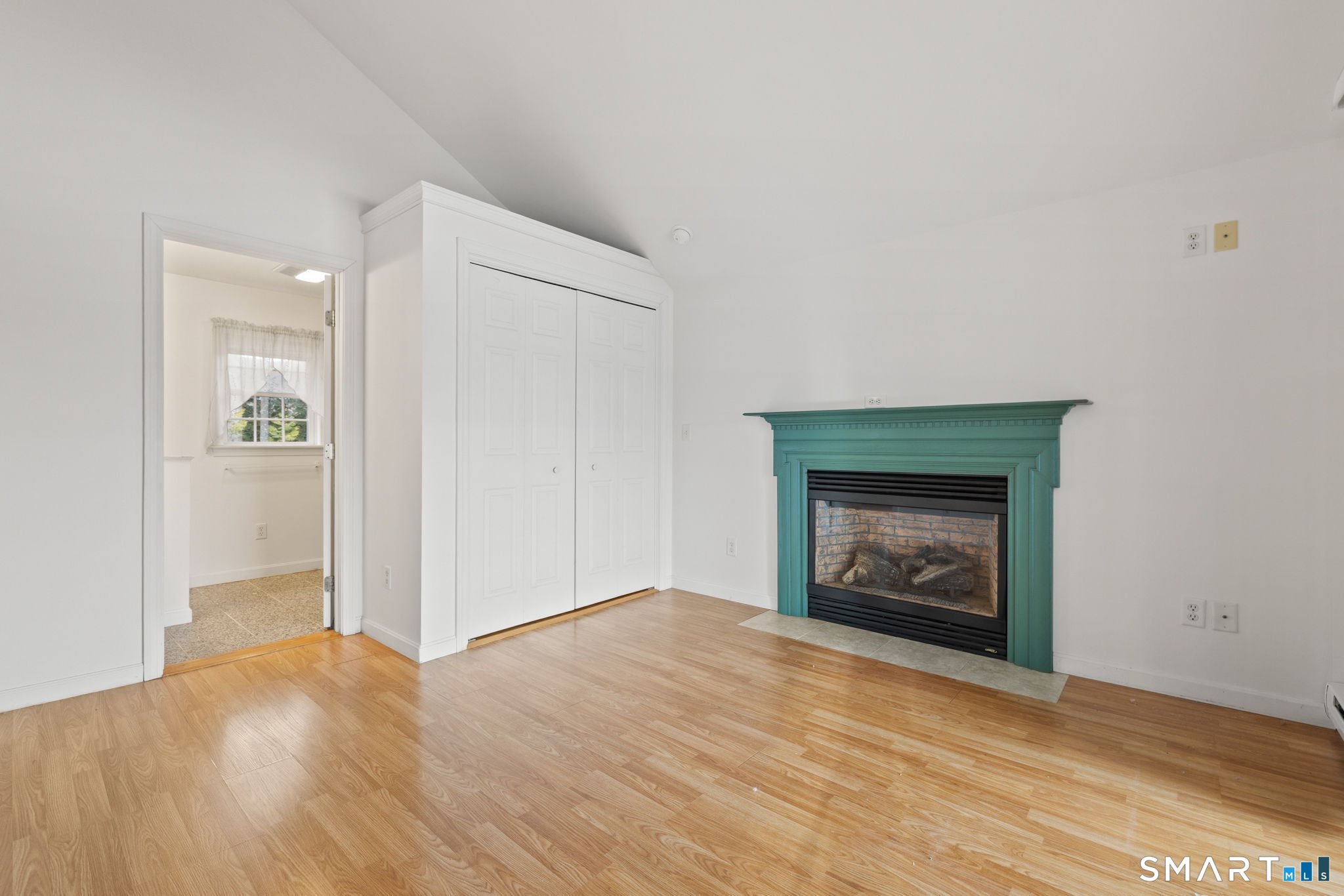 120 Kenwood Road Griswold, CT 06351 - Photo 14 of 34 an empty room with a fireplace and wooden floor