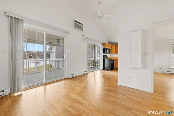 a view of empty room with wooden floor and entryway