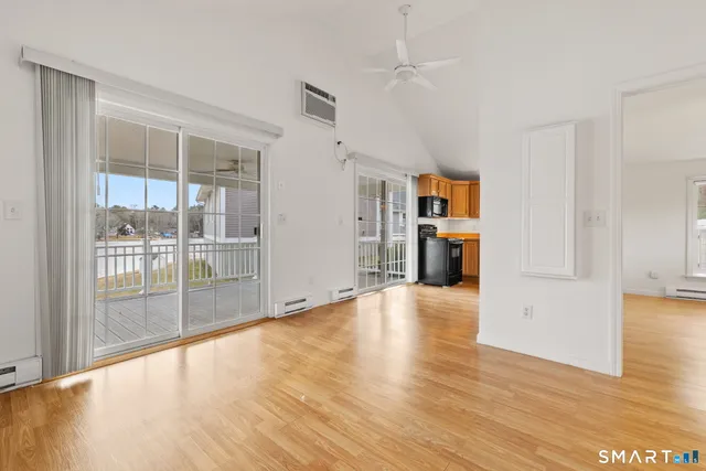 a view of empty room with wooden floor and entryway