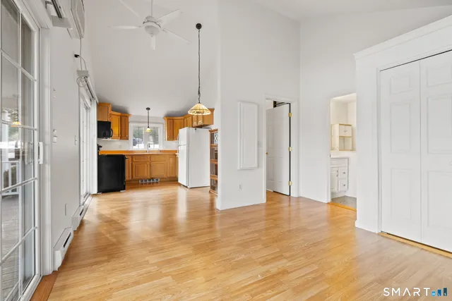 a view of a kitchen with a sink and a refrigerator