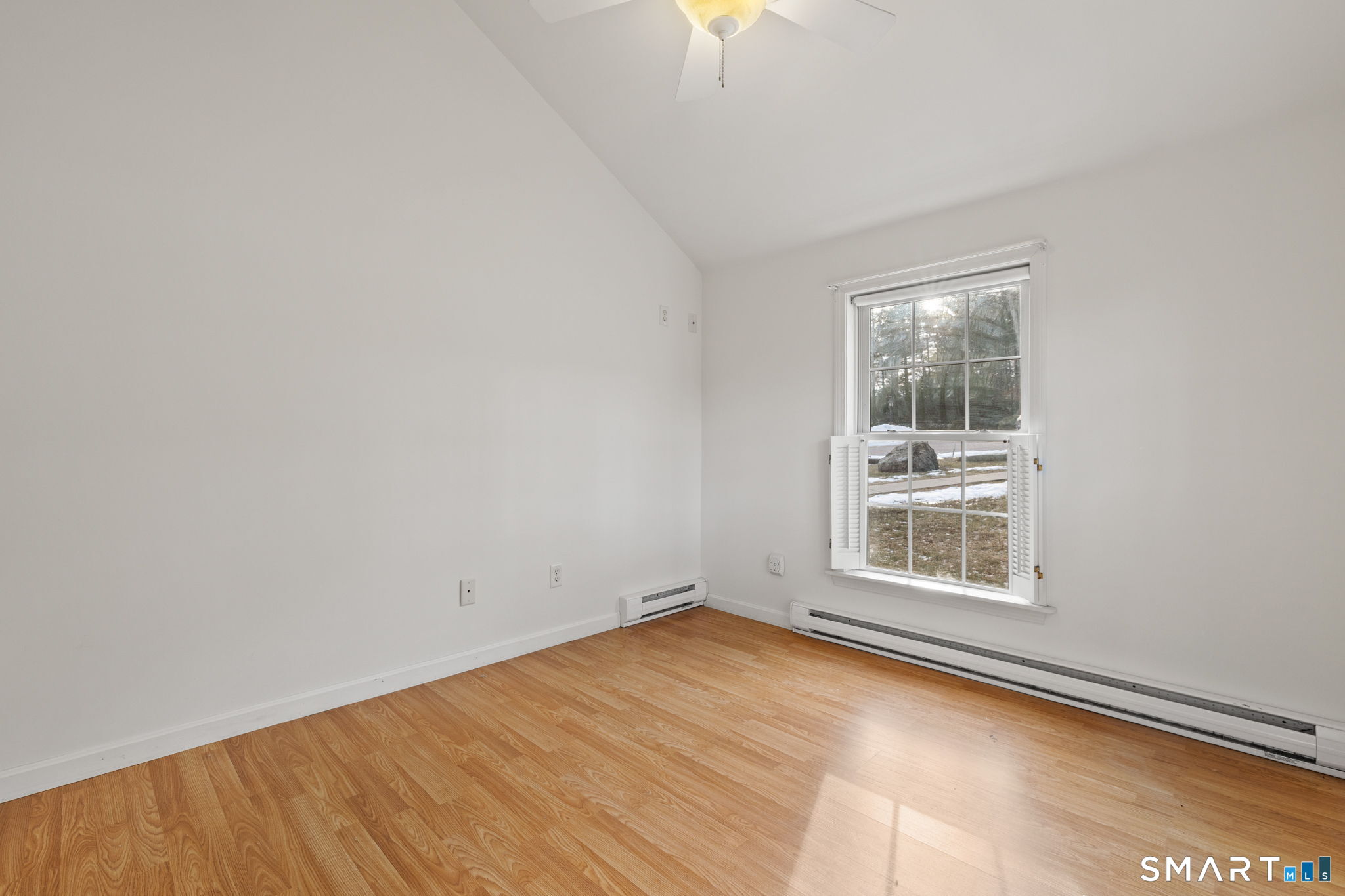 120 Kenwood Road Griswold, CT 06351 - Photo 20 of 34 an empty room with wooden floor and windows